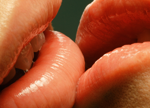 Couple with glossy lips kissing