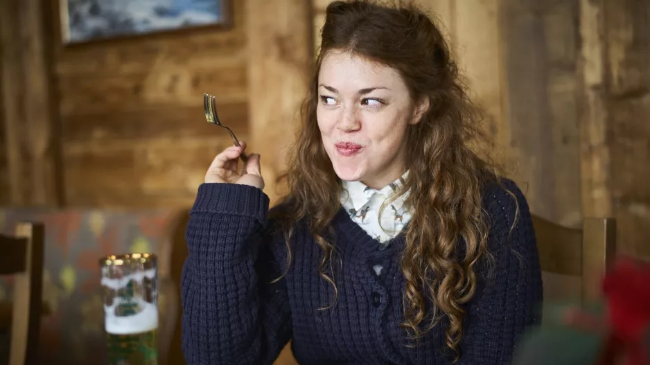 Happy woman eating out in a restaurant