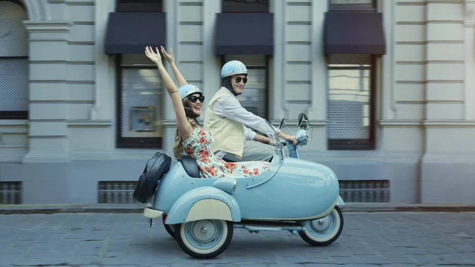 Couple driving scooter